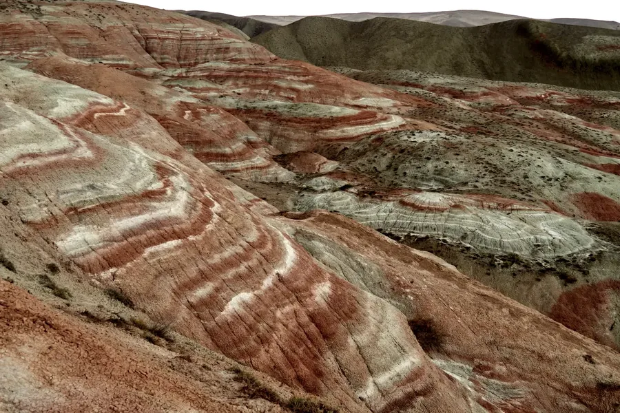 Hills striped in red and white bands of clay near Xizi.